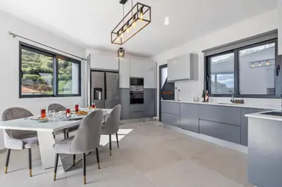 a kitchen and dining room with a white table and chairs at Landscape View by Homie in Canhas