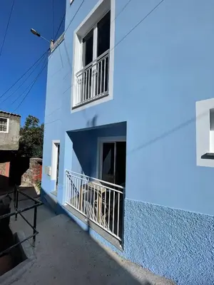 a stairway leading to a white building with a blue wall at Tides proprety - Medium Tide in Paul do Mar