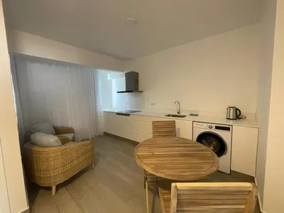 a small kitchen with a table and a sink at Tides proprety - Medium Tide in Paul do Mar