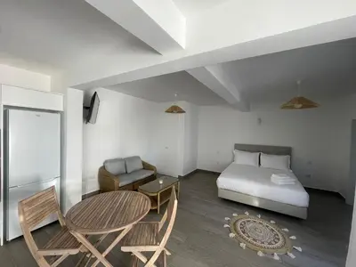 a bedroom with a bed and a table and a chair at Tides proprety - Low tide in Paul do Mar