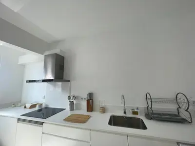 a white kitchen with a sink and a stove at Tides proprety - Low tide in Paul do Mar