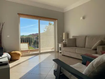 a living room with a couch and a large window at A Casa Lagos, Golf in Lagos