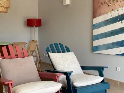 a room with chairs and a painting on the wall at A Casa Lagos, Golf in Lagos