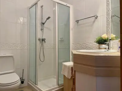 a bathroom with a shower and a toilet and a sink at A Casa Lagos, Golf in Lagos