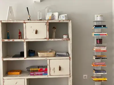 a book shelf with books and other items on it at A Casa Lagos, Golf in Lagos