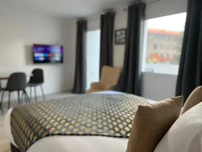 a hotel room with a bed and a window at Living Funchal iNN in Funchal