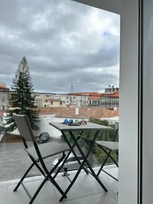 a table and two chairs on a balcony at Living Funchal iNN in Funchal