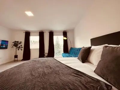 a bedroom with a large bed in front of a window at Living Funchal iNN in Funchal
