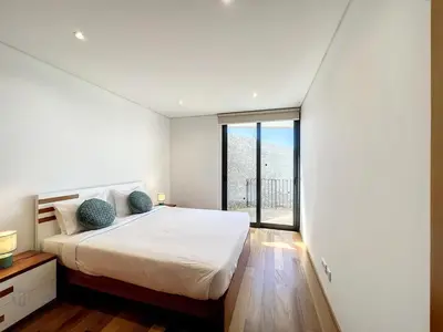 a bedroom with a bed and a large window at Casa Dream 2 in Calheta