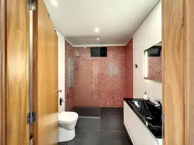 a bathroom with a toilet a sink and a shower at Casa Dream 2 in Calheta