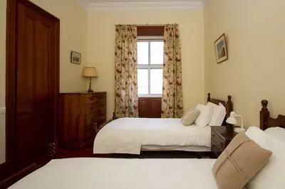 a bedroom with two beds and a window at Villa Quinta Santa Luzia in Funchal