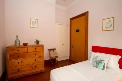 a bedroom with a bed and a dresser and a door at Villa Quinta Santa Luzia in Funchal