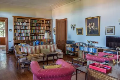 a living room filled with furniture and books at Villa Quinta Santa Luzia in Funchal