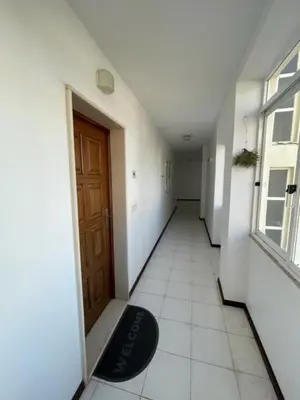 a hallway with a door and a rug on the floor at O Nosso Recanto in Machico
