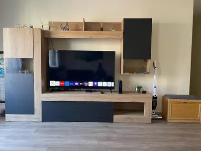 a entertainment center with a large television in a living room at O Nosso Recanto in Machico
