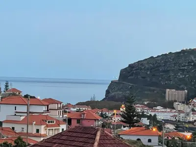 a view of a town with a mountain in the background at O Nosso Recanto in Machico