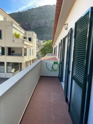 a balcony of a building with a view of a mountain at O Nosso Recanto in Machico