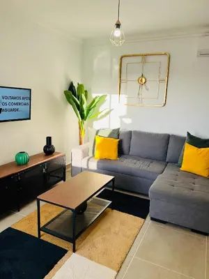 a living room with a couch and a table at New Flat surround by beaches. in Sagres