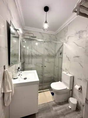 a bathroom with a shower and a toilet and a sink at New Flat surround by beaches. in Sagres