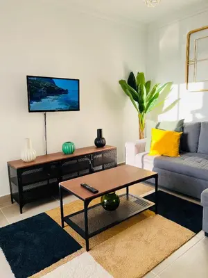 a living room with a couch and a coffee table at New Flat surround by beaches. in Sagres