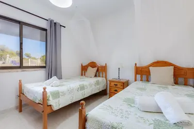 a bedroom with two beds and a window at Casa Teresinha - V028 in Montinhos da Luz