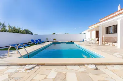 a villa with a swimming pool and a house at Casa Teresinha - V028 in Montinhos da Luz