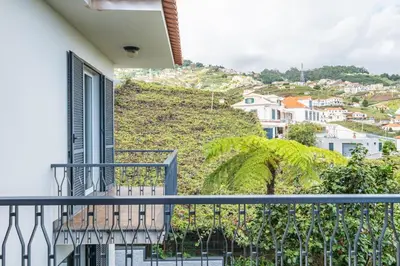 a balcony with a view of a hill at Casa Olimpo by Homie in Estreito de Câmara de Lobos