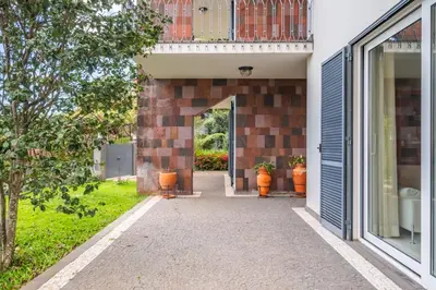 an entrance to a house with a brick wall at Casa Olimpo by Homie in Estreito de Câmara de Lobos