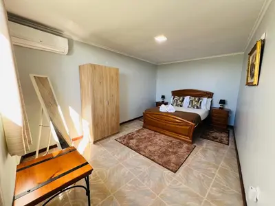 a bedroom with a bed and a wooden cabinet at Noite's House I - Prazeres in Prazeres