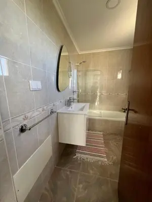 a bathroom with a sink and a tub and a mirror at Noite's House I - Prazeres in Prazeres