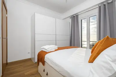 a white bedroom with a bed and a window at Il Tramonto by Homie in Ribeira Brava