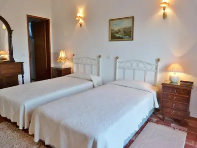 a bedroom with two beds and a dresser and two lamps at Casa Katarina in Luz