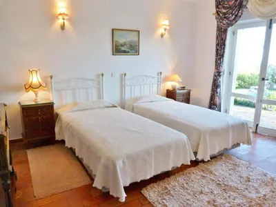 a bedroom with two beds and a window at Casa Katarina in Luz