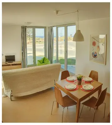 a living room with a table and a couch at Atlantic Sagres in Sagres