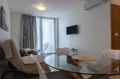a living room with a glass table and chairs at Atlantic Sagres in Sagres