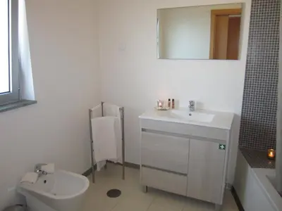 a bathroom with a sink and a toilet and a mirror at Atlantic Sagres in Sagres