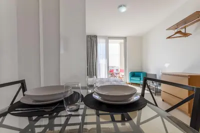 a dining room with a glass table with plates on it at Atlantic Sagres in Sagres