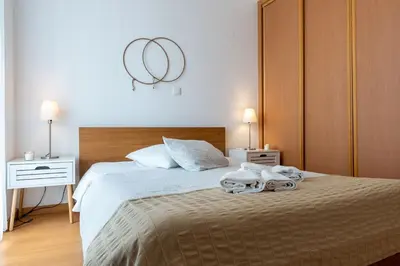 a bedroom with a bed with two towels on it at Atlantic Sagres in Sagres