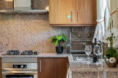 a kitchen with a sink and a stove top oven at Casa do Palheiro Ribeirinho by Rent-a-key in Porto Moniz