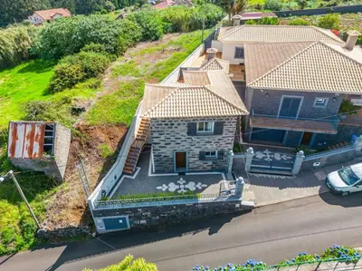an aerial view of a house with a yard at Casa do Palheiro Ribeirinho by Rent-a-key in Porto Moniz