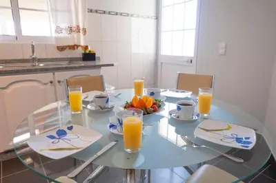 a glass table with oranges and glasses of orange juice at Villa Sol da Candelária by GALMI in Ribeira Brava