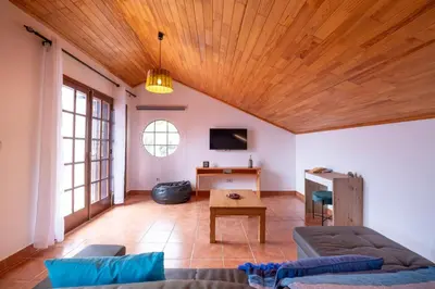 a living room with a couch and a table at Casa del Mar I by GALMI in Arco de São Jorge