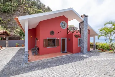a red house with a stone driveway at Casa del Mar I by GALMI in Arco de São Jorge