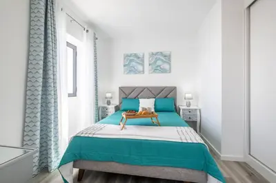 a bedroom with a bed with blue and white at Villa Otto by GALMI in Campanário