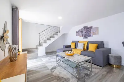 a living room with a blue couch and a table at Villa Otto by GALMI in Campanário