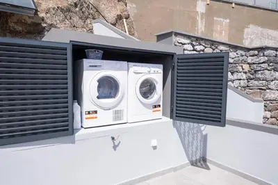 a washer and dryer in a window on a building at Villa Otto by GALMI in Campanário