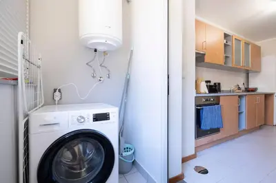 a laundry room with a washing machine in a kitchen at Wings Apartment CE by GALMI in Santa Cruz