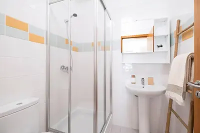a bathroom with a shower and a sink at Wings Apartment CE by GALMI in Santa Cruz