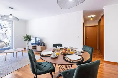 a dining room with a table and chairs at Wings Apartment CE by GALMI in Santa Cruz