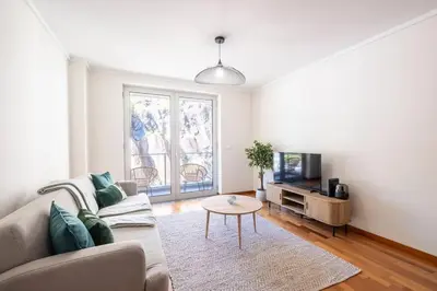 a living room with a couch and a tv and a table at Wings Apartment CE by GALMI in Santa Cruz
